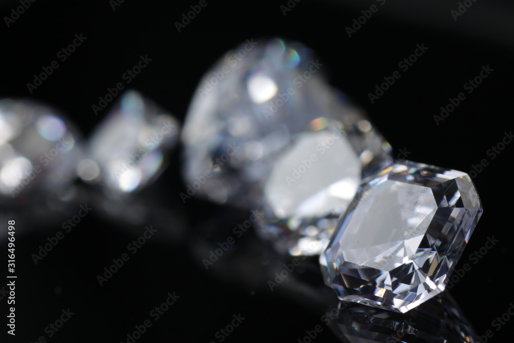 Macro shoots of a group of diamonds that has different shapes, heart, round, pear, asscher, oval, princess, isolated background Macro shoots of a group of diamonds that has different shapes, heart, round, pear, asscher, oval, princess, isolated background