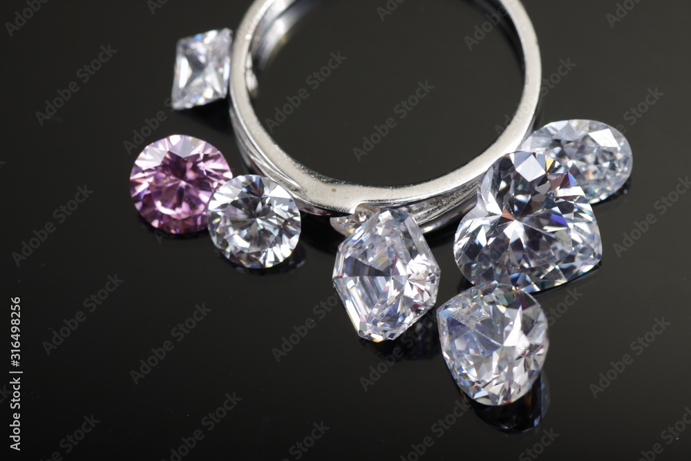 Macro shoots of a group of gold wedding ring and diamonds that has different shapes, heart, round, pear, asscher, oval, princess, isolated background Macro shoots of a group of gold wedding ring and diamonds that has different shapes, heart, round, pear, asscher, oval, princess, isolated background