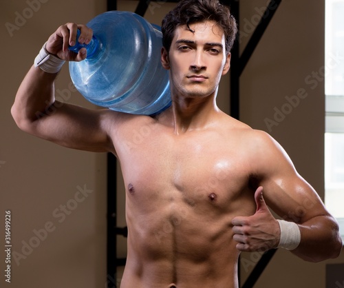 Muscular ripped man with big water bottle