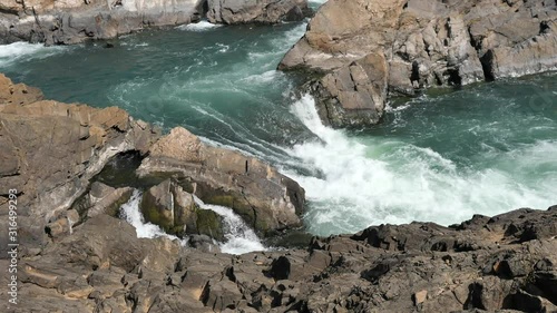 Sopheakmit or Preah Nimith waterfall, Islands with Brown Cliffs with Green rapids and large waterfalls in the Mekong River, Stung Treng, Cambodia photo