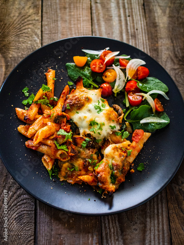 Pasta casserole with barbecue chicken breast, cheese and vegetables