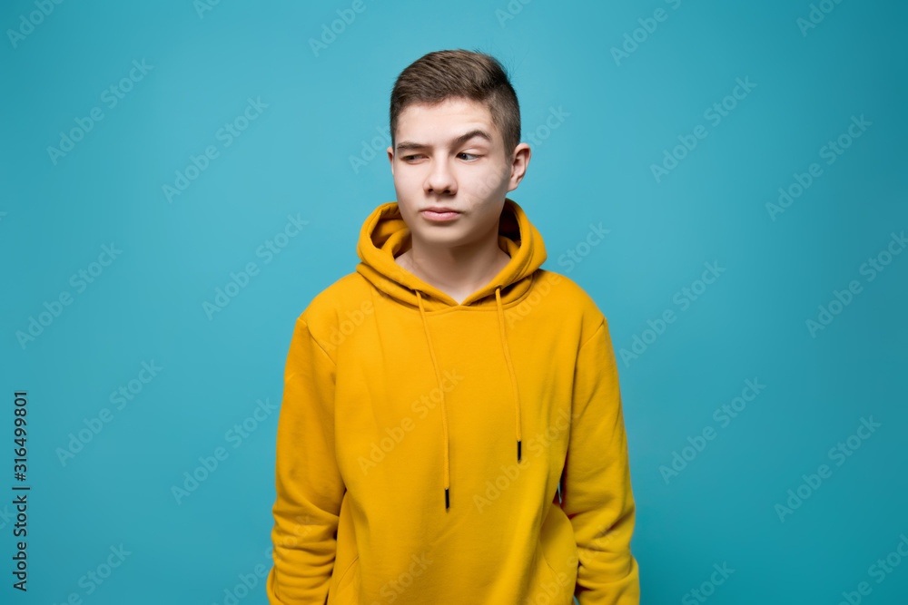 A young man looks with interest at an imaginary object to his left A young man looks with interest at an imaginary object to his left