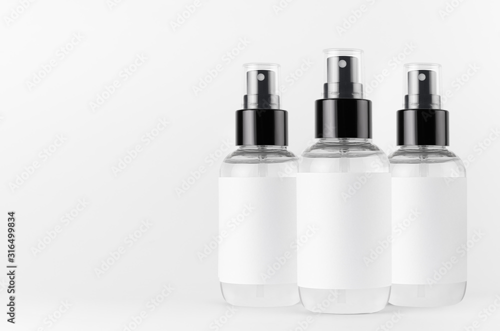 Transparent spray bottles for cosmetics product with white blank label on white background, mock up for branding, advertising, presentation, design. Transparent spray bottles for cosmetics product with white blank label on white background, mock up for branding, advertising, presentation, design.