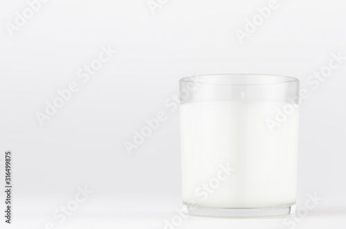 White candle in transparent glass on white background, mock up for branding identity product, advertising, presentation, design of packing.