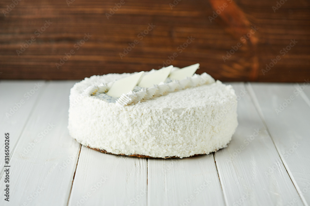 Birthday cake with white chocolate, butter cream and poppy seed biscuit on wooden background Birthday cake with white chocolate, butter cream and poppy seed biscuit on wooden background