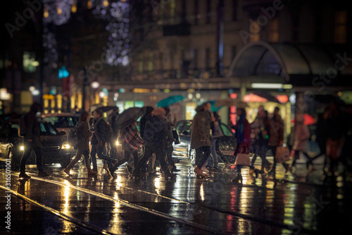 crowd of people walking on night streets in city