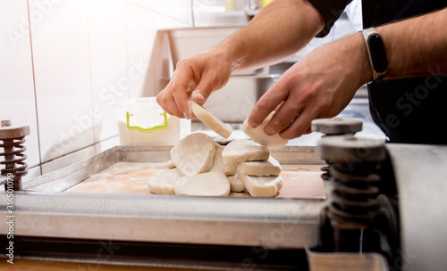 Chef preparing dough for pastry, dumplings, italian pasta or japanese wontons. Cooking. Restaurant kitchen.