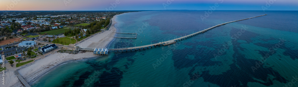 Panoramic aerial dawn view of the iconic Busselton Jetty and the town in the backgreound, which is located 220 km south west of Perth, Western Australia