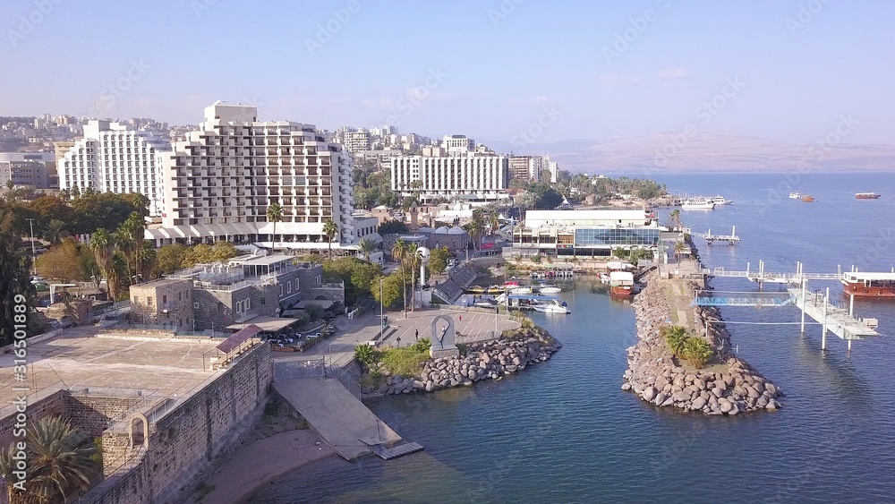 Sea of Galilee in Tiberias, Israel. Aerial view of the coastline, the old city and the hotels zone.