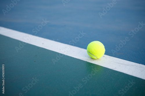 tennis ball on a tennis court © shersor