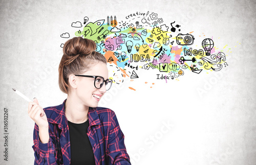 Cheerful nerd girl with glasses, creative idea