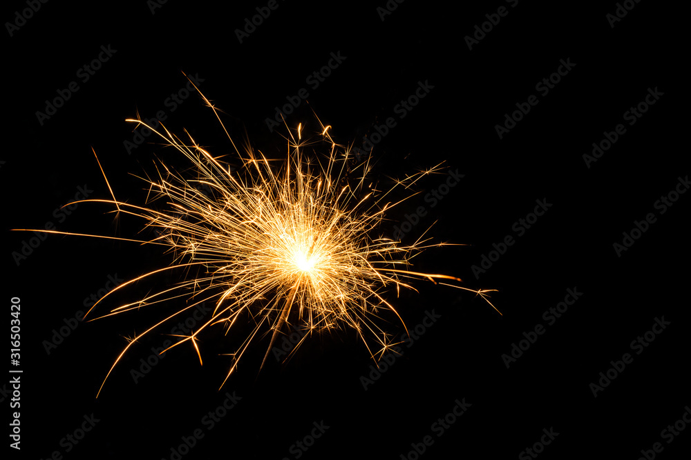 Magic burning sparkler on night background