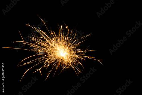 Magic burning sparkler on night background