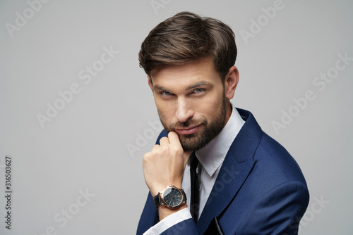 Studuo shot of thinking businessman wearing suit photo