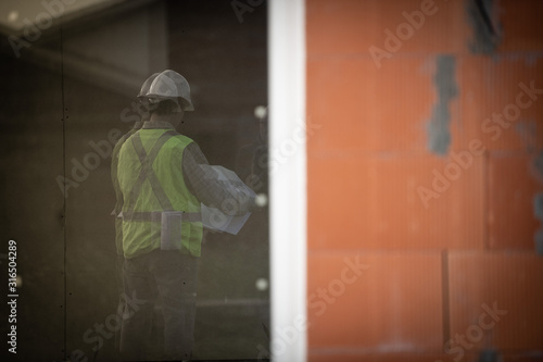 Professional engineer architect worker with protective helmet at house building construction site background