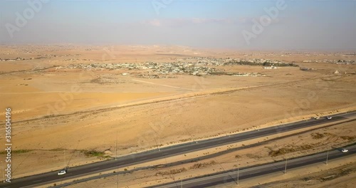 Aerial footage over Desert road with Bedouin settlements, Israel Rout 25, Dimona Beer sheba road, Bedouin settlements, Drone shot, Negev Israel photo