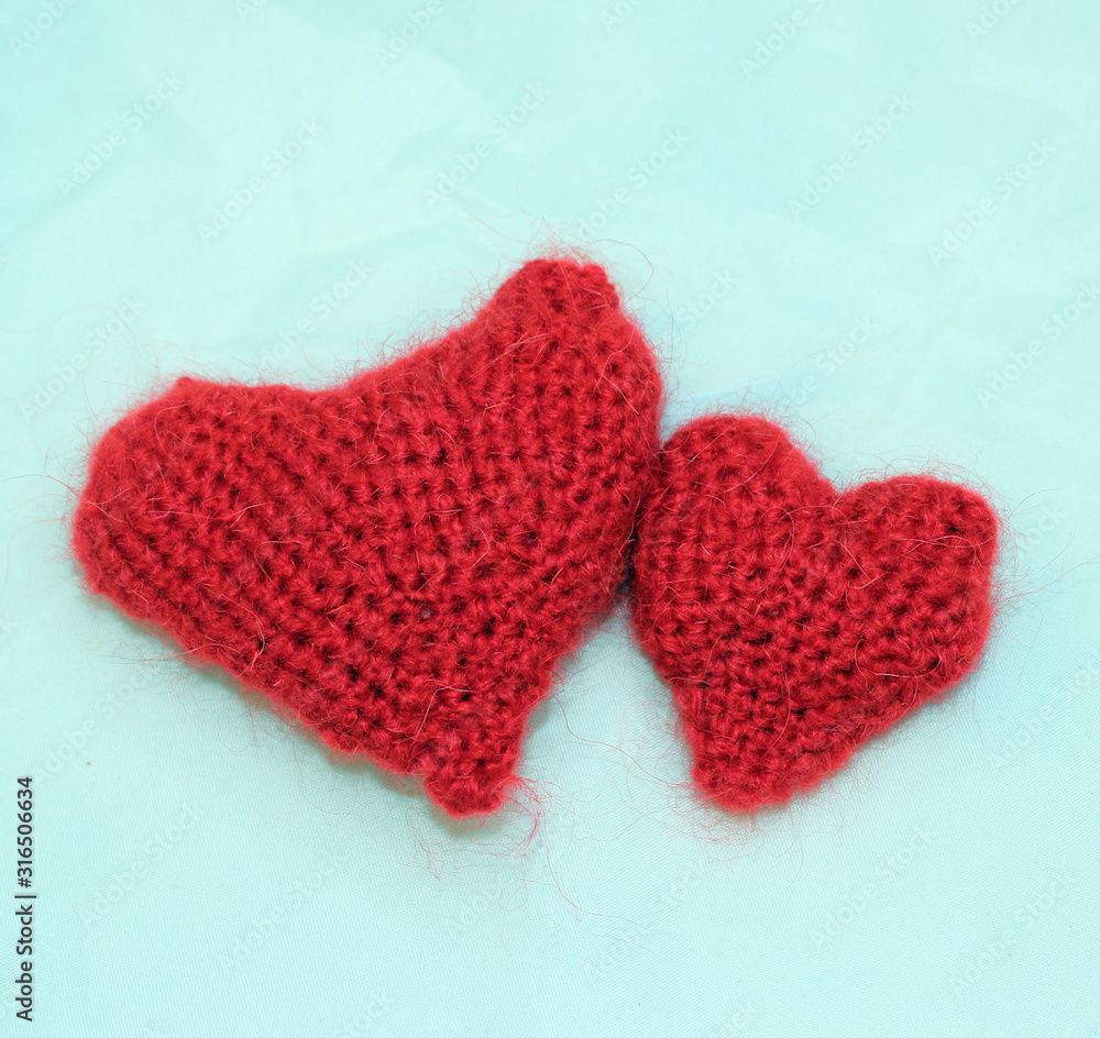 Two knitted red hearts
