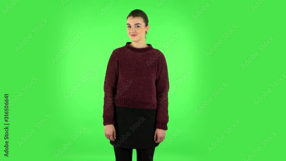 Woman coquettishly smiling while looking at camera. Green screen Woman coquettishly smiling while looking at camera. Green screen