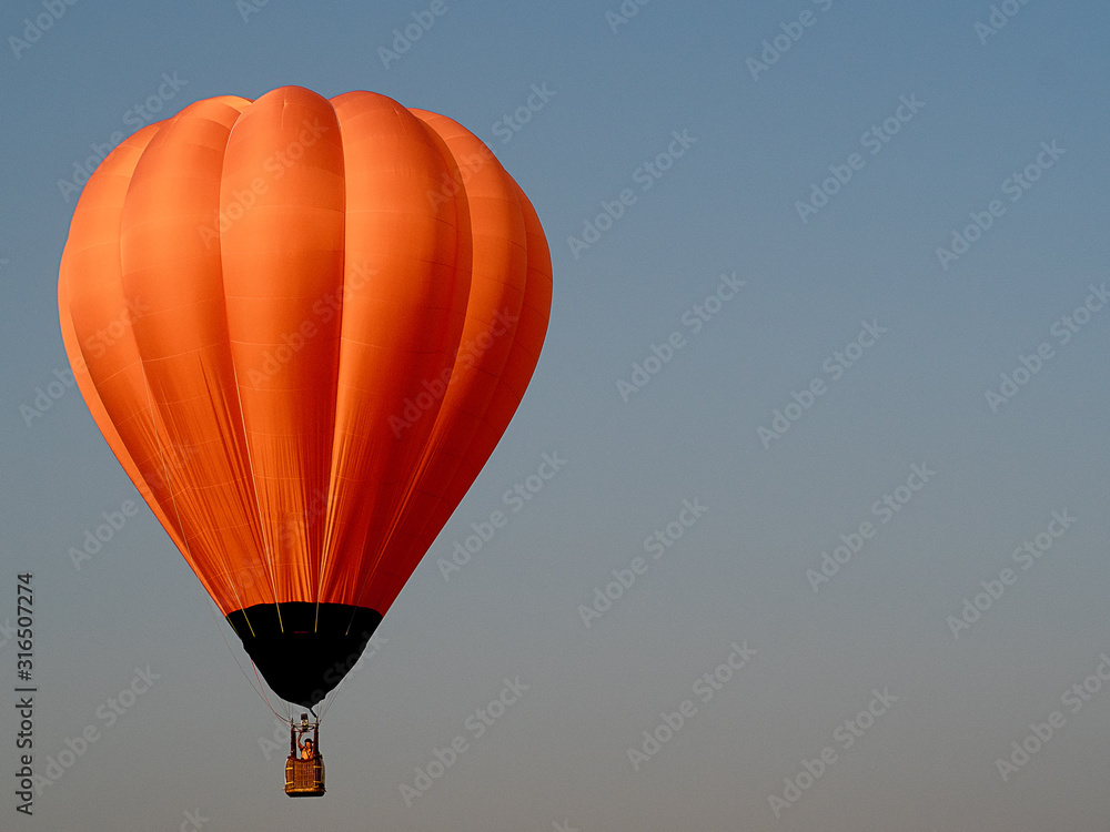 Fototapeta premium Beautiful orange air balloon on the sky