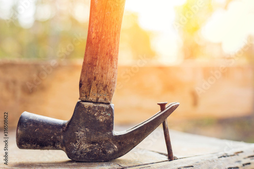 Hammer and nail on wood,Use a hammer to pry the nails. Woodworking, Construction Sites photo