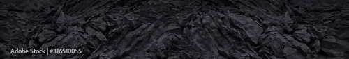 Black mountain texture closeup. Long grunge banner. The geometric shape of th...