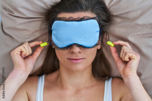 Canvastavla Sleeping female using eye mask and earplugs for better sleeping, noise protectio