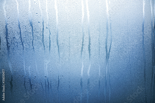 Blue Glass with Condensate, Window with Steam and Water as Background or Texture 