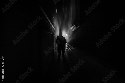 Dark corridor with cabinet doors and lights with silhouette of spooky horror person standing with different poses.