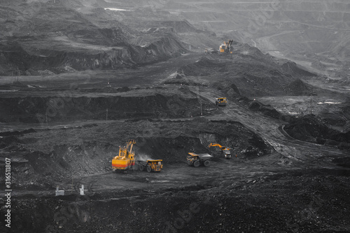 Cuadro en lienzo Open pit mine, coal loading in trucks, transportation and logistics