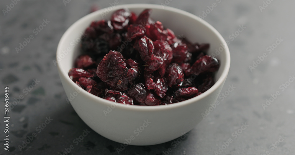 closeup dried cranberry in white bowl on terrazzo countertop closeup dried cranberry in white bowl on terrazzo countertop
