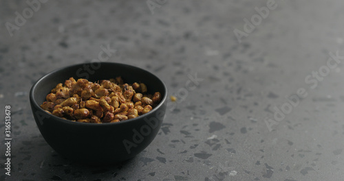 dried seaberry in black bowl on terrazzo countertop