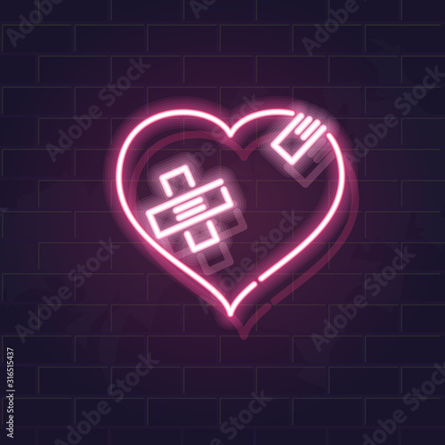 Neon wounded heart silhouette with crossed band patches. Fluorescent icon on brick wall background. Concept image for love relationship.