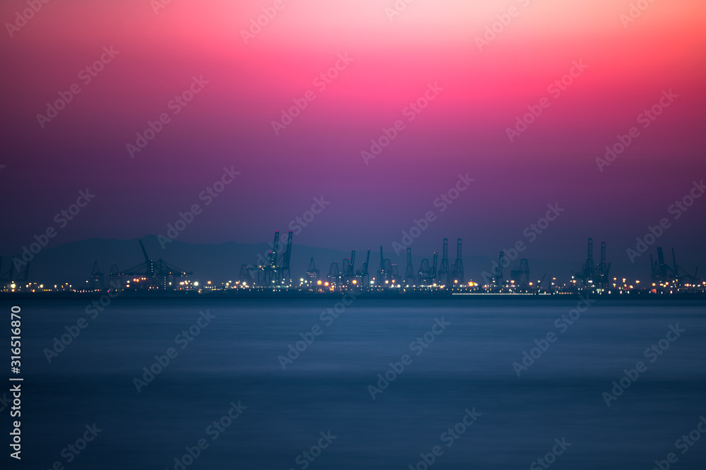Pink sunset over the commercial dock with cranes