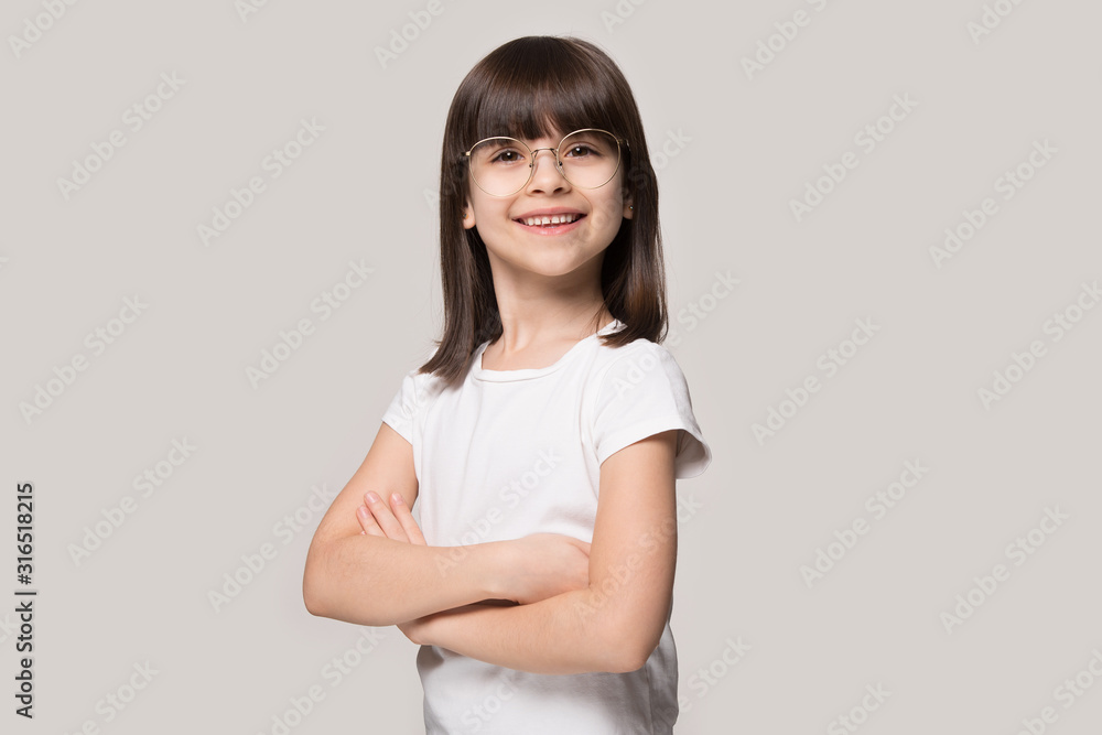 Studio portrait of confident happy girl wearing eyeglasses. Studio portrait of confident happy girl wearing eyeglasses.