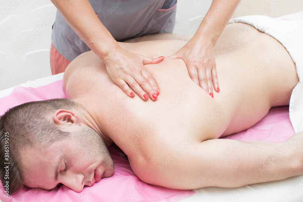 The procedure for sports massage for an athlete is done by a woman in a massage parlor. The procedure for sports massage for an athlete is done by a woman in a massage parlor.