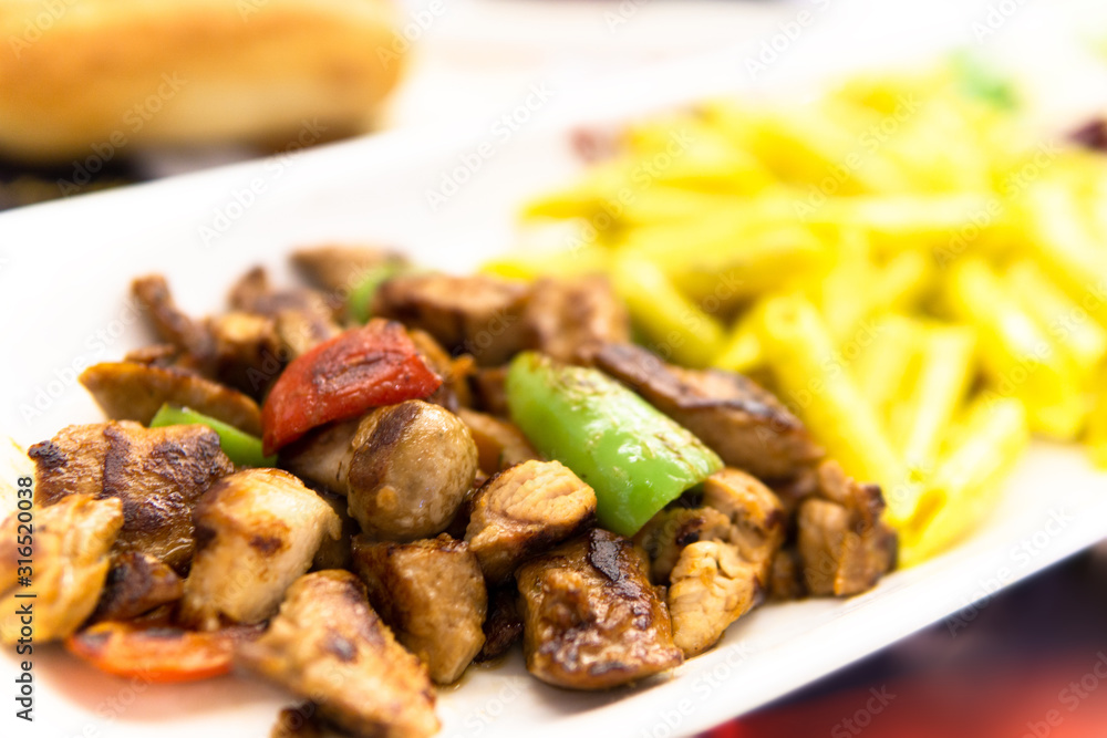 chicken saute meal with green pepper and tomato in white plate chicken saute meal with green pepper and tomato in white plate