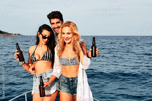 a group of young people drinking beer in a boat - summer concept © alvaro