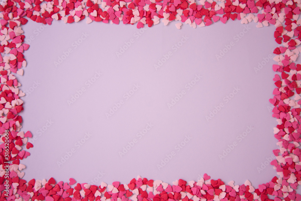 Rectangular frame with small multicolored hearts on a pink background, the concept of Valentine's Day. Postcard. Rectangular frame with small multicolored hearts on a pink background, the concept of Valentine's Day. Postcard.