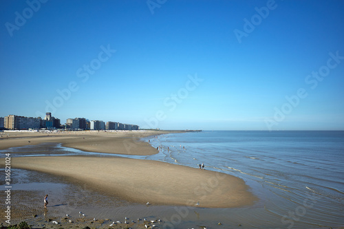 Blankenberge,Belgium - Aug 31,2019: Empty beach on a summer day in the Belgian province of West Flanders photo