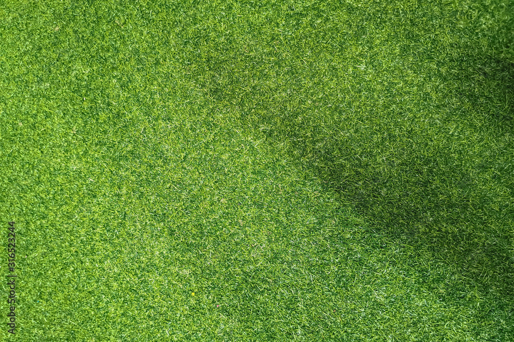 Obraz premium Green background from artificial grass. Copy space.