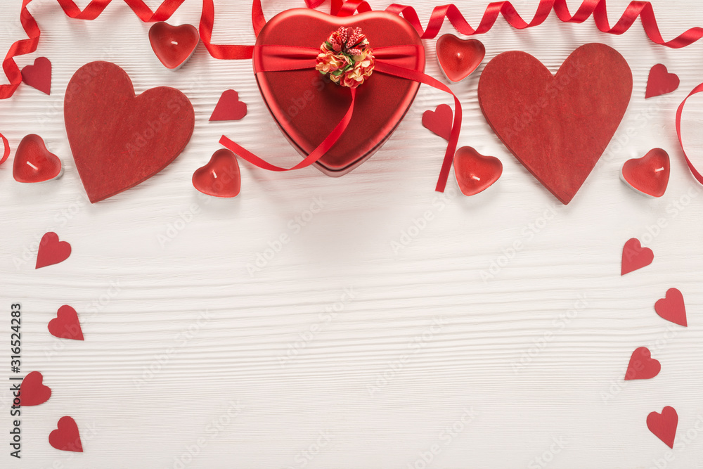 Valentine day composition: gift box and red hearts	