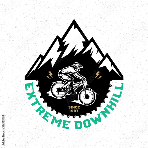 Vector downhill mountain biking badge, logo, label with rider on a bike and mountain silhouette. Downhill, enduro, cross-country biking illustration