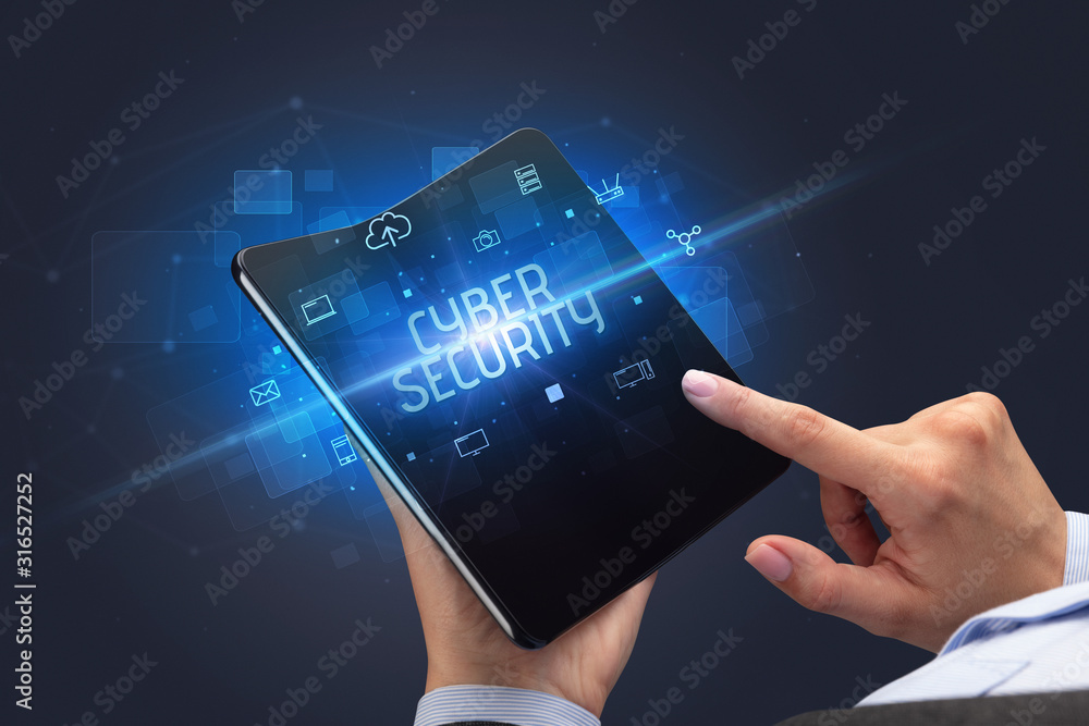 Businessman holding a foldable smartphone with CYBER SECURITY inscription, cyber security concept Businessman holding a foldable smartphone with CYBER SECURITY inscription, cyber security concept