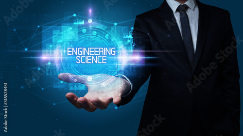 Man hand holding ENGINEERING SCIENCE inscription, technology concept