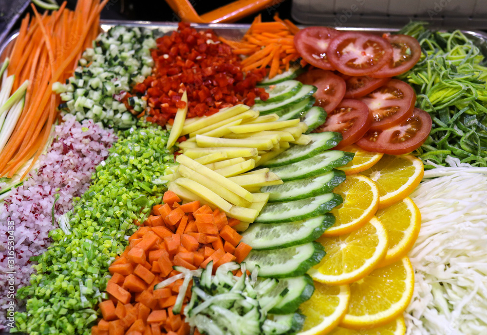 Different raw shredded vegetables and fruits as an example of a healthy diet