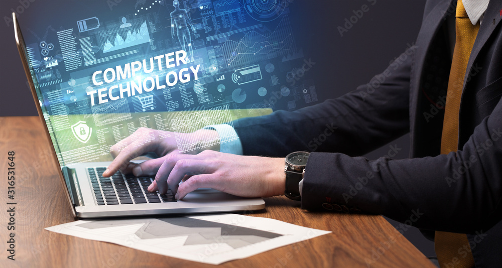 Businessman working on laptop with COMPUTER TECHNOLOGY inscription, cyber technology concept Businessman working on laptop with COMPUTER TECHNOLOGY inscription, cyber technology concept