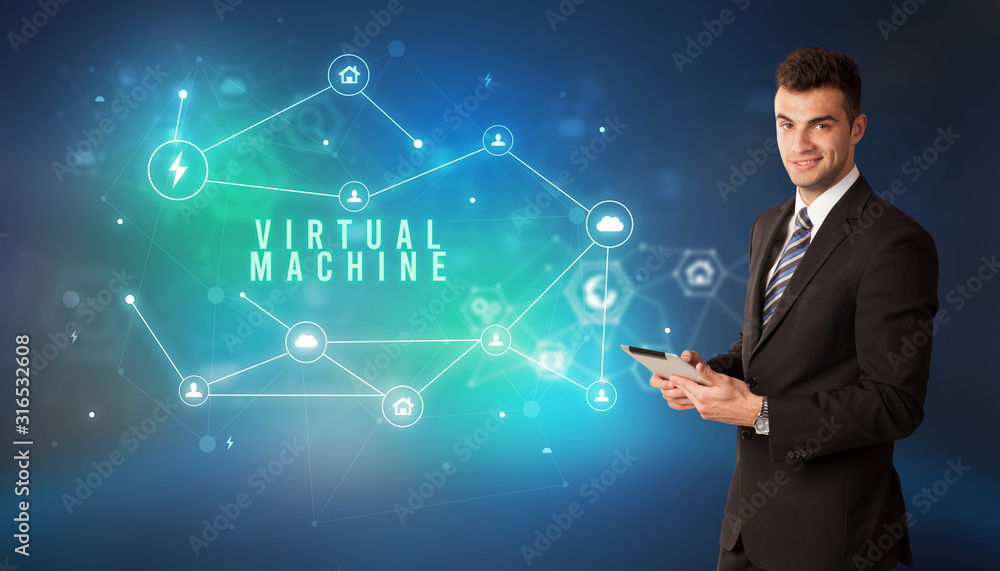 Businessman in front of cloud service icons with VIRTUAL MACHINE inscription, modern technology concept Businessman in front of cloud service icons with VIRTUAL MACHINE inscription, modern technology concept