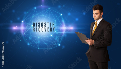 Businessman thinking about security solutions with DISASTER RECOVERY inscription