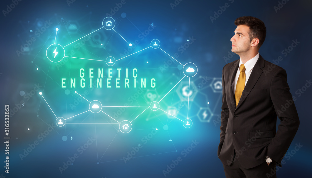 Businessman in front of cloud service icons with GENETIC ENGINEERING inscription, modern technology concept Businessman in front of cloud service icons with GENETIC ENGINEERING inscription, modern technology concept