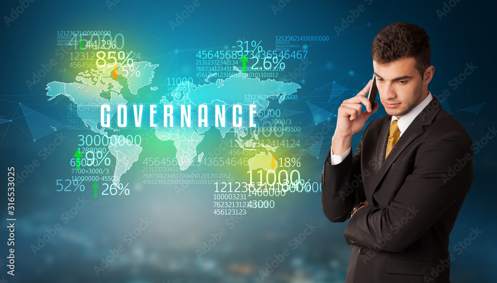 Businessman in front of a decision with GOVERNANCE inscription, business concept Businessman in front of a decision with GOVERNANCE inscription, business concept